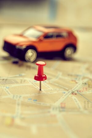 travel concept - small toy car on the mapの写真素材