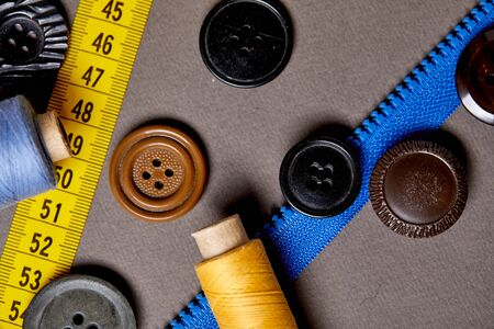 Background and texture of multicolored antique buttons and sewing tools