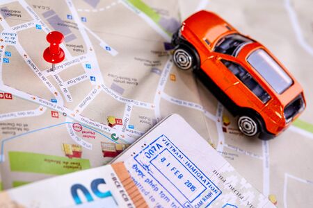 travel concept - small toy car on the map