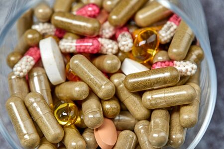 medicine pills and capsules on grey surfaceの写真素材