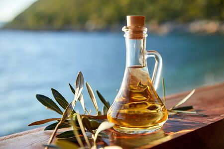 olive oil in the bottle and ripe olivesの写真素材
