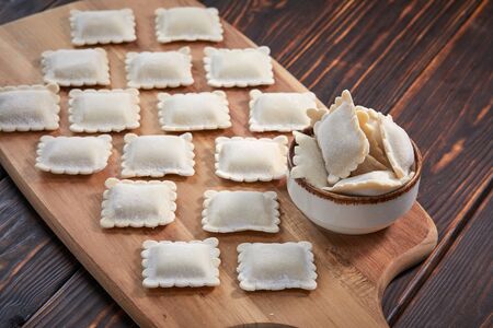 raw dumplings on teh wooden boardの写真素材