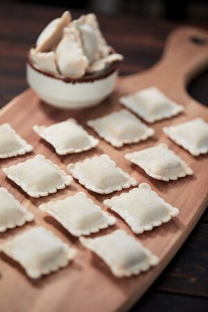 raw dumplings on teh wooden boardの写真素材