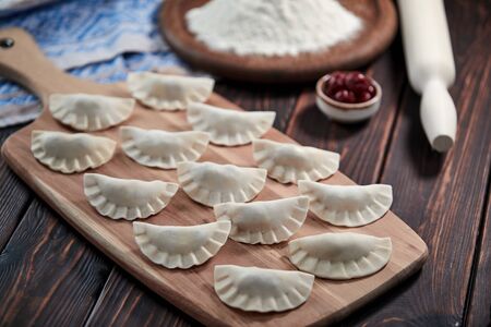 raw dumpling with cherries on the wooden boardの写真素材