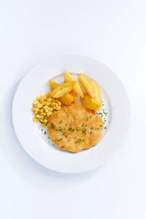 schnitzel with potatoes on white