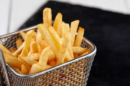 fried french fries in the basketの写真素材