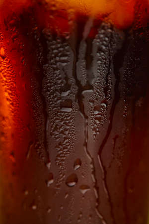 Ice cubes in cola beverageの写真素材