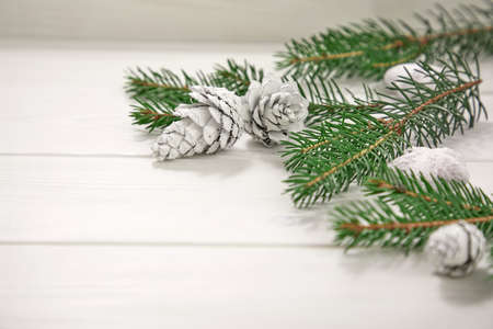 Christmas card - Christmas tree branches on the wooden background