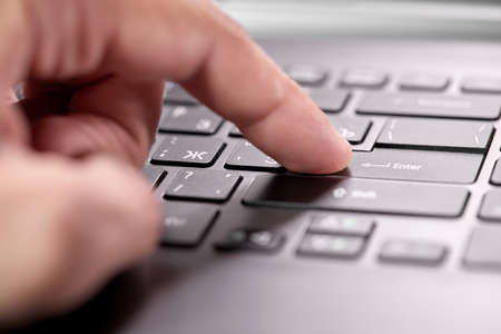 working on computer, close up of hand on keyboardの写真素材