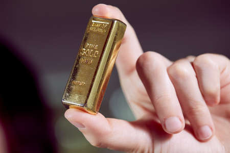 golden bar on the man's handの写真素材