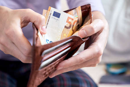 man hand putting money, closeupの写真素材