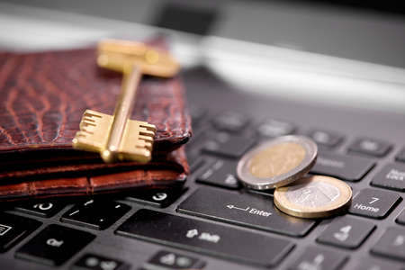 money coins on laptop computer