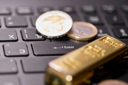 money coins on laptop computer