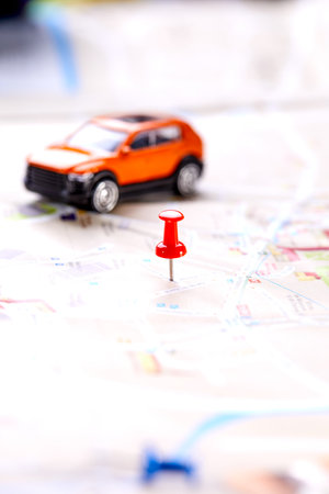 travel concept - small toy car on the mapの写真素材