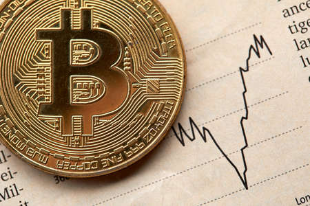 Gold Bitcoin on the background of the chart.