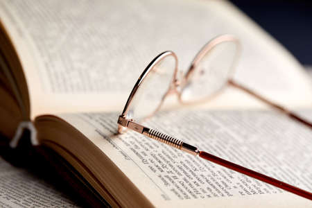 glasses on the book pagesの写真素材