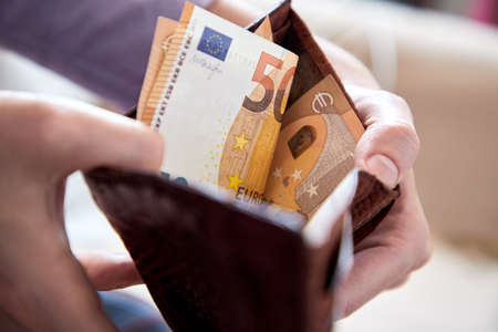 man hand putting money closeupの写真素材