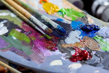 Tubes of oil paint, palette and artist paintbrushes closeupの写真素材
