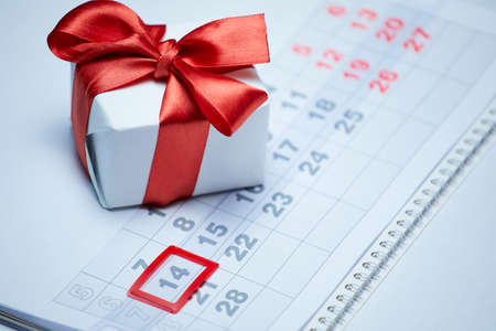 Valentine's day, a gift on a calendar sheet.の写真素材