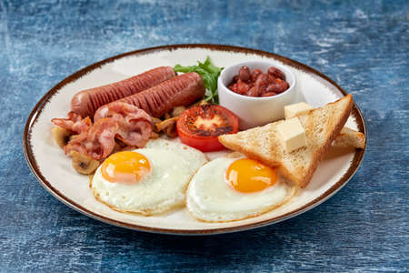 traditional breakfast with eggs and sausagesの写真素材