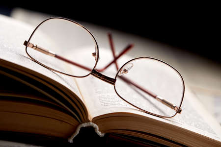 glasses on the book pagesの写真素材