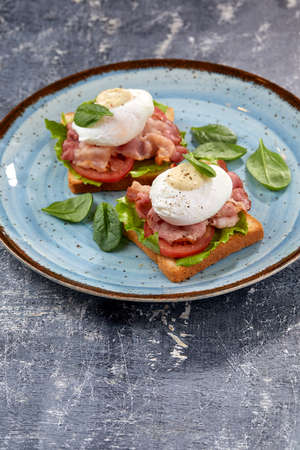 toasts with poached egg and baconの写真素材
