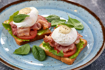 toasts with poached egg and baconの写真素材