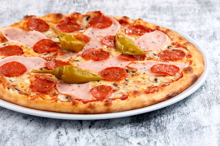 fresh pizza on the white plateの写真素材