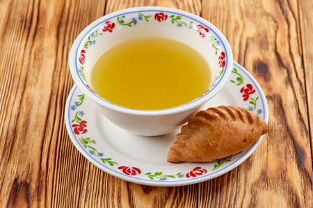 Hot meat broth with fresh cereal bunの写真素材