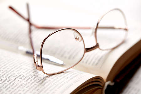 glasses on the book pagesの写真素材