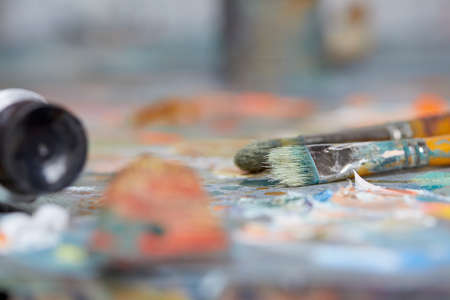 Tubes of oil paint, palette and artist paintbrushes closeupの写真素材