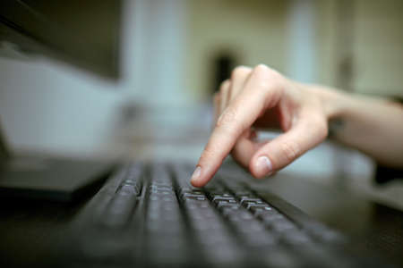 Female hands or woman office worker typing on the keyboardの写真素材