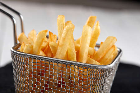 fried french fries in the basketの写真素材