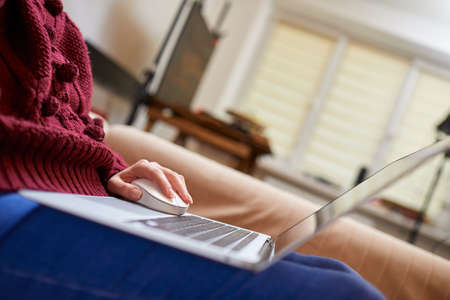 Beautiful woman relaxing at home with notebookの写真素材
