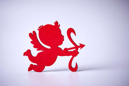 red Cupid shooting on the white backgroundの写真素材