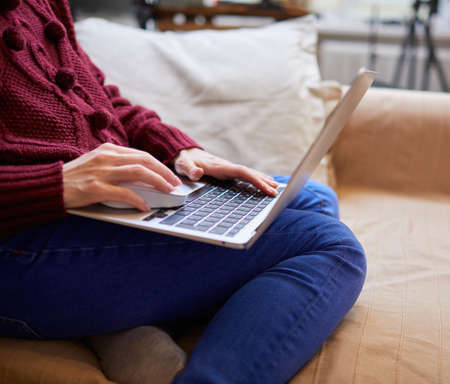 Beautiful woman relaxing at home with notebookの写真素材