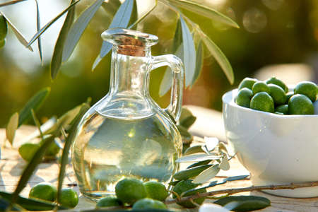 olive oil and green olives on the tableの写真素材