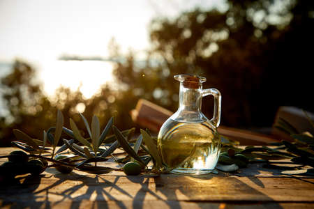 olive oil and green olives on the tableの写真素材