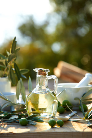 olive oil and green olives on the tableの写真素材