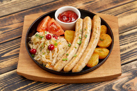 baked potatoes with sausages and cabbageの写真素材