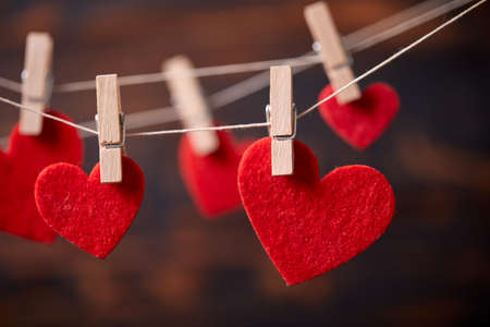 Red heart on wooden clothespinの写真素材