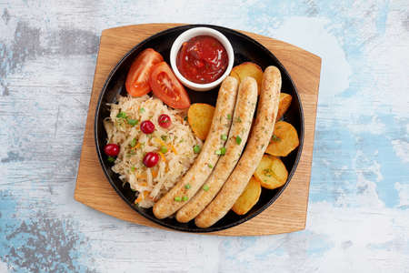 baked potatoes with sausages and cabbageの写真素材