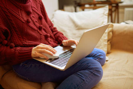Beautiful woman relaxing at home with notebookの写真素材