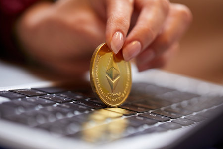 Hand holding golden bitcoin ethereumの写真素材