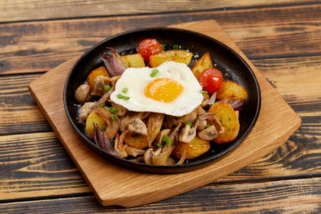 baked potatoes with mushrooms and eggsの写真素材