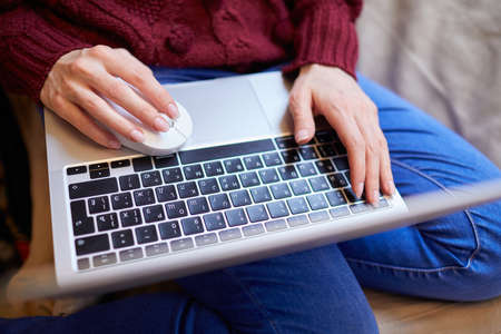 Beautiful woman relaxing at home with notebookの写真素材