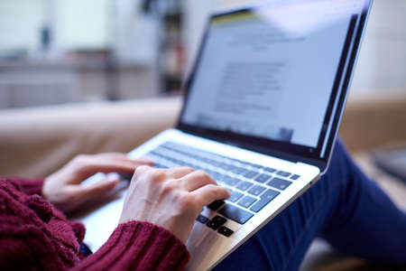 Beautiful woman relaxing at home with notebook