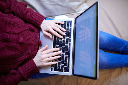 Beautiful woman relaxing at home with notebookの写真素材