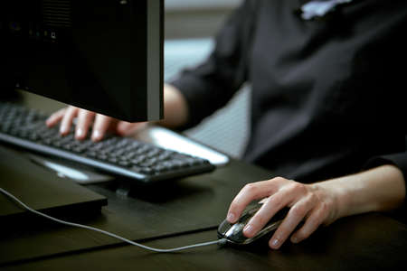 Female hands or woman office worker typing on the keyboardの写真素材