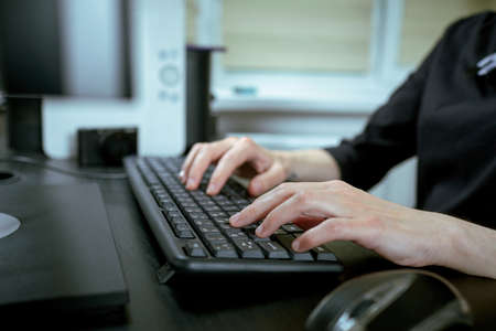 Female hands or woman office worker typing on the keyboardの写真素材